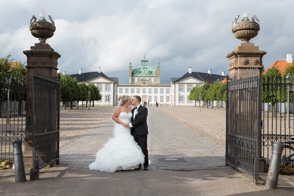 Parbilleder af nygift brudepar. Et kys foran Fredensborg Slot